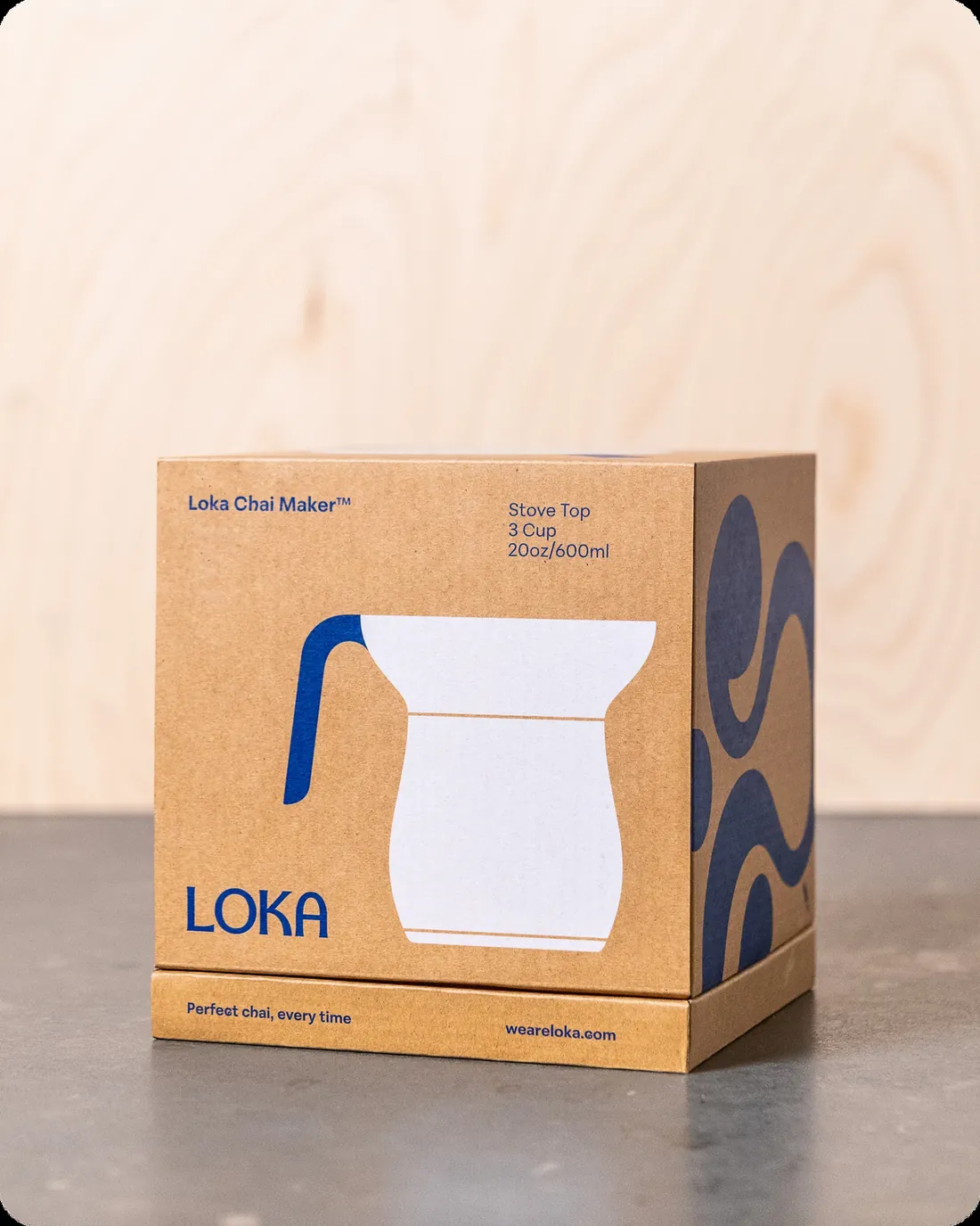 The Chai Maker box, in tan card with a navy illustration