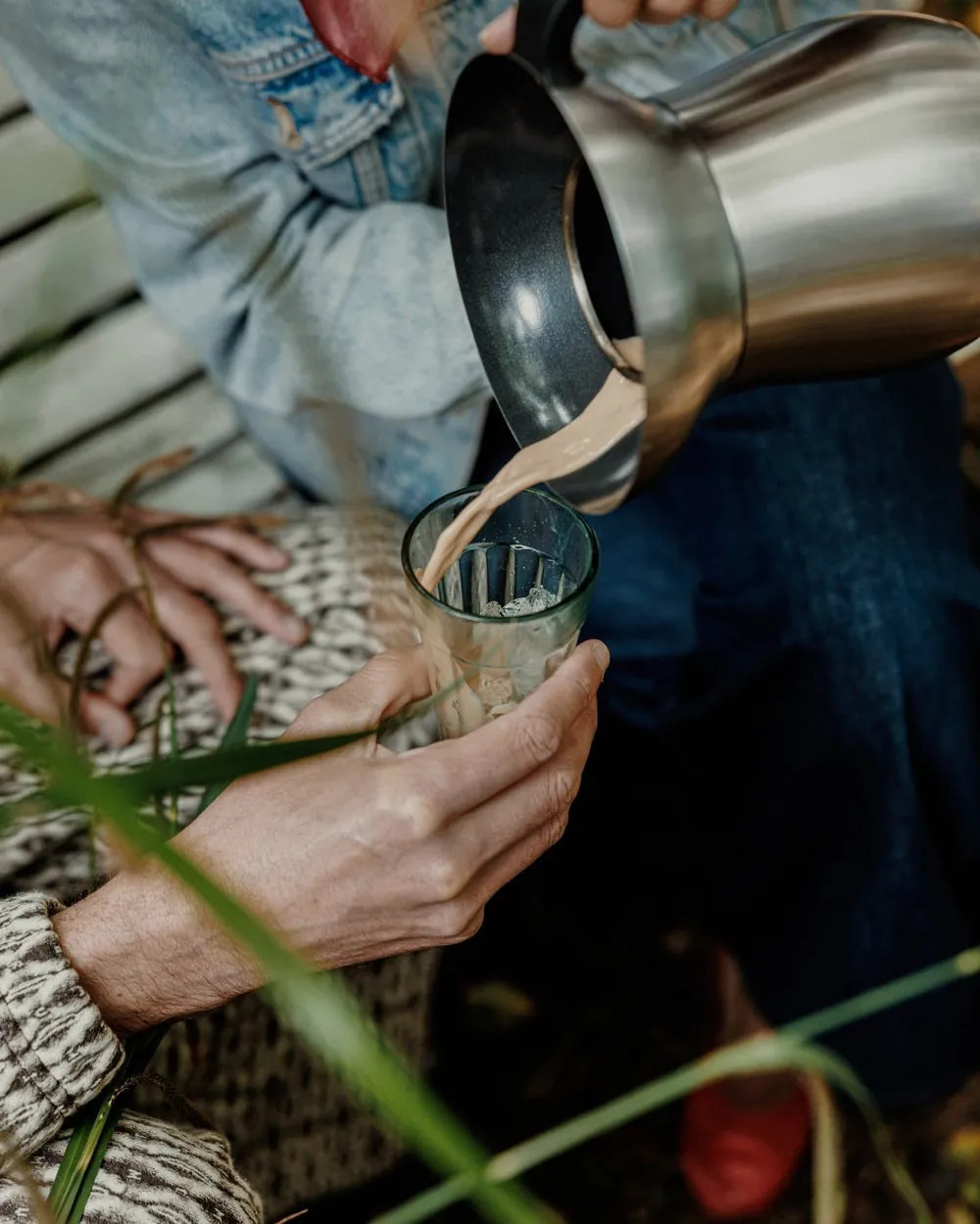 Chai being poured from the Chai Maker into a glass outdoors
