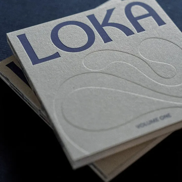 Loka Journal Volume One, a grey magazine with the Loka logo